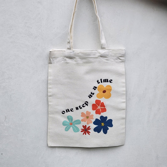 One step at a time Tote bag